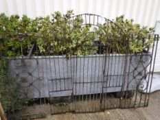 A wrought iron garden gate of small proportion, together with a pair of painted metal panels of