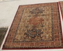A pair of New Zealand wool rugs, the central panels set with three floral decorated medallions on