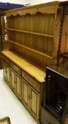 A 20th Century pitch pine dresser with boarded two tier plate rack over three drawers and three