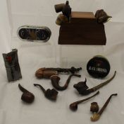A large collection of various wooden pipes to include some with the pipe bowl in the form of a