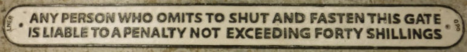 A modern cast iron sign inscribed "LNER - Any person who omits to shut and fasten this gate is