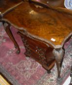A mahogany side table in the 18th Century manner, raised on shell carved cabriole legs to paw