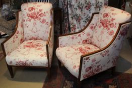 A pair of Regency mahogany and satinwood arm chairs with red floral decorated and cream ground