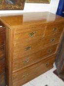 A late Victorian/Edwardian ash square fronted chest of two short over three long drawers on a plinth
