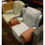 A modern armchair in blue and cream checked upholstery raised on ringed and turned legs to brass