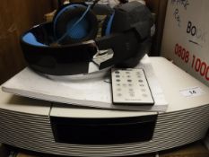 A Bose Wave radio / CD and a pair of Kotion Each headphones