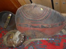 A collection of Ethnographica/Tribal items including two hide shields, two spears, fly whisks,
