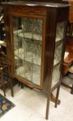 An Edwardian mahogany and inlaid bow fronted leaded glazed display cabinet with painted floral