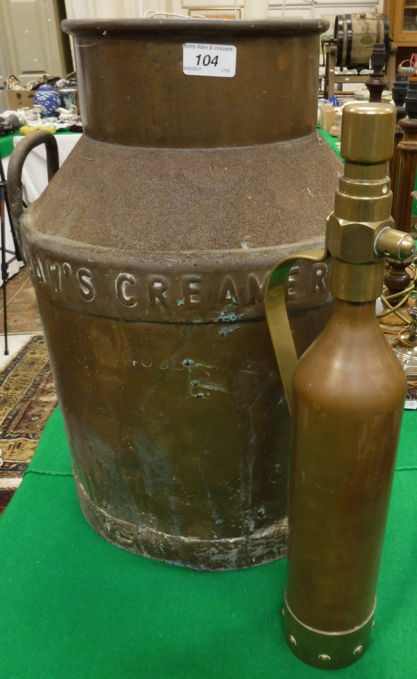 A Daw's Creameries copper and iron churn, together with a vintage brass and copper fire
