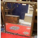 A rectangular overmantle mirror in a gilt and gesso frame with rope-twist mouldings