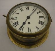 A brass cased ship's style wall clock with Arabic and Roman numerals, together with a 19th Century