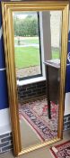 A 20th Century rectangular wall mirror in a moulded gilt frame