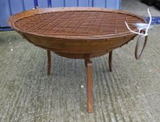 A modern firepit with twin loop handles and studded decoration raised on stand*