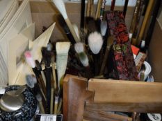 A box containing various Chinese brush painting implements, brushes, palettes etc and a collection