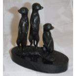 A modern chocolate patinated bronze figure group of three meerkats on a black marble base