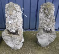 A pair of composite stone lion statues, each holding blank shields