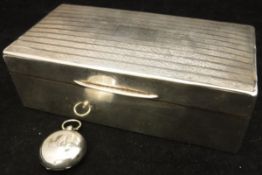 A George V silver mounted cigarette box (Birmingham 1924) with engine turned decoration and