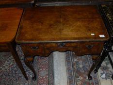 An 18th Century style walnut lowboy, the plain top with cross banded decoration above a single