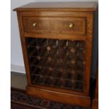 A burr oak and cross banded 25 section wine rack with single drawer,