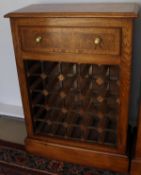 A burr oak and cross banded 25 section wine rack with single drawer,