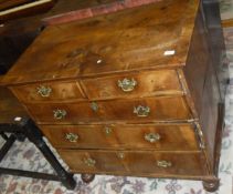 A 18th Century walnut and cross banded chest, the quartered and cross banded top above two short and