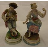 A pair of late 19th Century Continental matt polychrome decorated biscuit fired figures of