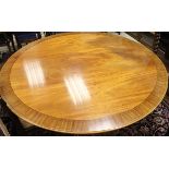 A circular mahogany and banded dining table in the Regency taste,