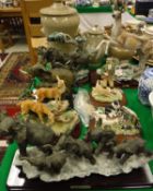 Four Julianna Collection resin animal figures including three of elephants and two of deer, two