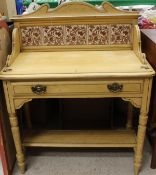 A Victorian pine washstand with three-quarter galleried top and tiled back and painted decoration,