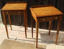 A pair of walnut and banded single drawer side tables on square section tapering supports
