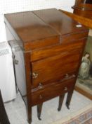 A Regency mahogany night table with double rising top above a cupboard drawer and commode drawer