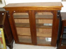 A Victorian mahogany two door display cabinet with two glazed doors enclosing shelves
