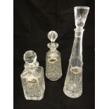 Two pairs of Caithness crystal coloured glass wines, three decanters with bottle tags, pair of