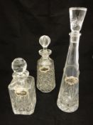 Two pairs of Caithness crystal coloured glass wines, three decanters with bottle tags, pair of