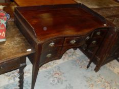 An Edwardian mahogany and inlaid dressing table with three quarter galleried top above a