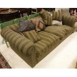 A modern three seat sofa with scroll arms and patterned striped brown upholstery with various