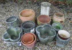 A collection of garden pots to include a pair of composite stone pots and a composite stone pillar