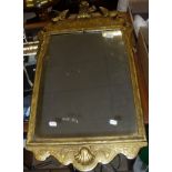 A 20th Century gilt framed wall mirror with moulded decoration and one further mirror