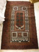 A Turkish prayer rug, the central panel set with architectural style panels on a dark red and