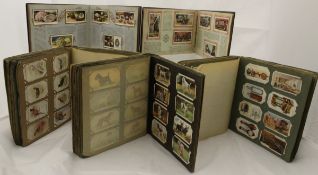 A box containing 14 various cigarette card albums to include Gallaghers, Players, Wills and