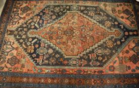A Caucasian style rug, the central panel set with lozenge-shaped medallion on a red ground with