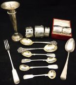 A collection of silver wares to include a cased pair of napkin rings with engraved leaf
