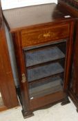 An Edwardian and satinwood banded music cabinet with raised back over a single glazed door, raised