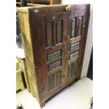 An Eastern painted pine two panelled door cupboard enclosing three shelves to stile feet