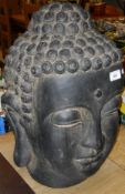 A large pottery Buddha head in the Khmer style