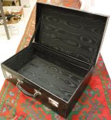 A black leather covered suitcase