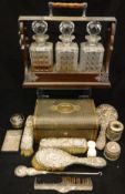 A collection of silver wares to include various dressing table bottles, hand mirror,