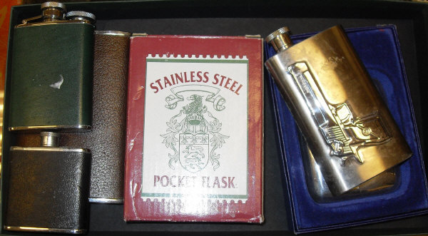 A copper and brass coaching horn, together with six various modern hip flasks including one by