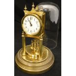A brass cased 365 day clock by Gustav Beckler under glass dome