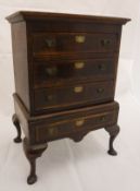 A walnut miniature chest on stand in the early 18th Century manner, the upper section with three